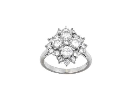 A Diamond Cluster Ringthe central raised round brilliant cut diamond within a border of four larger round brilliant cut diamo