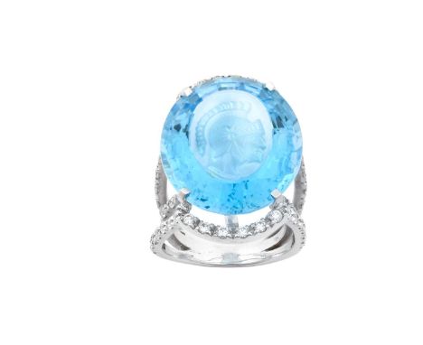A Blue Topaz and Diamond Intaglio Ringthe oval cut blue topaz carved to depict a Centurion in white claw settings, to a parti