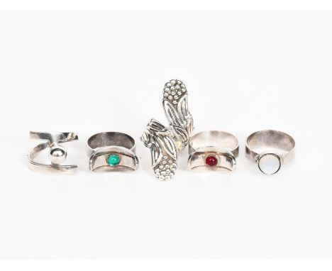 An English silver ring set with polished moonstone cabochon, a pair of English silver rings, with curved collar set with gree