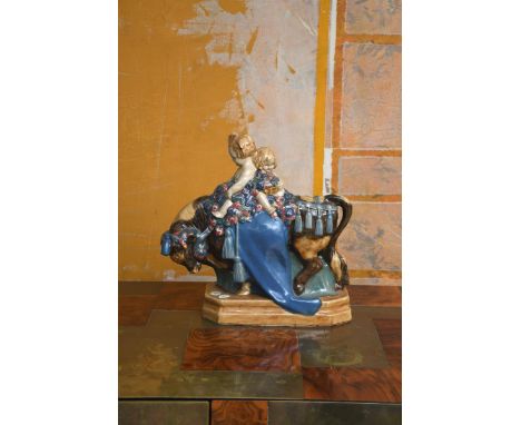 'The Bull' a large Hammersmith Bridge stoneware figure by Harold Stabler, dated 1914, modelled as two young children riding o