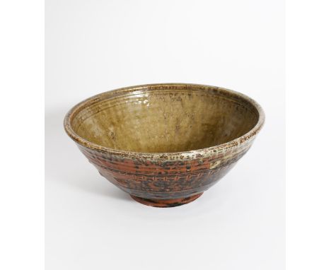 Richard Batterham (1936-2021) a large stoneware bowl, flaring form on shallow foot, the exterior glazed tenmoku with ash runs