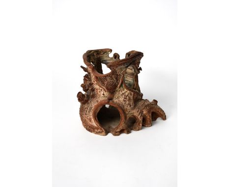 A Portland sculpture by Guy Sydenham, modelled as a pierced tree trunk with anthropomorphic features, glazed in colours impre