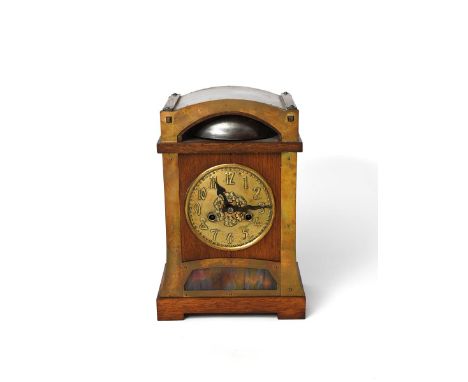 An Arts and Crafts oak and brass mantle clock possibly retailed by Liberty &amp; Co,  tapering rectangular section, with circ