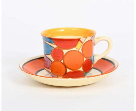 'Berries' a Clarice Cliff Fantasque Bizarre tea cup and saucer, painted in colours, the saucer with orange and black bands, p