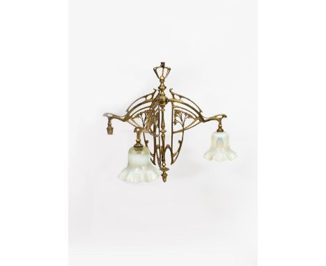 An Art Nouveau brass three light ceiling light, cast and pierced with stylised whiplash berried sprays, the three radiating b