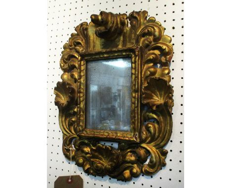 WALL MIRROR, 18th century Italian giltwood with distressed plate of compact proportions, 39cm H x 31cm W.