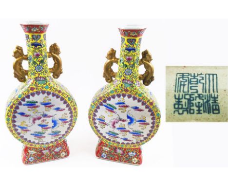CHINESE MOON FLASKS, a pair, 20th century ceramic decorated traditional designs on famille jaune grounds, 43cm H. (2)