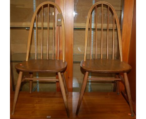 A pair of Ercol light elm stickback dining chairs