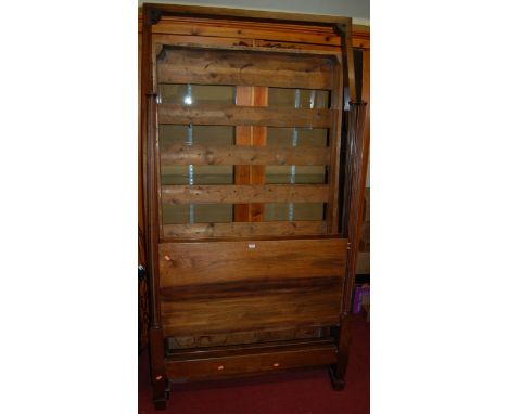 A late 19th century French mahogany single tester bed, having fixed pine slatted base section, raised on fluted end panel hea