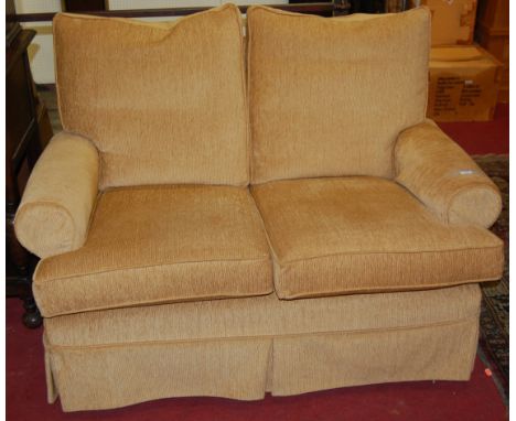 A contemporary straw coloured upholstered two-seater sofa, width 135cm