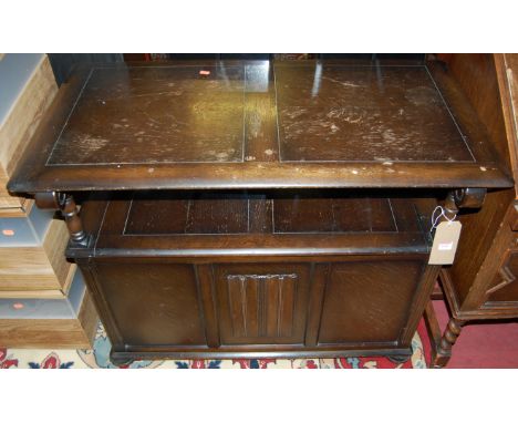 A moulded oak fold-over monks bench, having typical hinged box seat base with linenfold panelled decoration, width 101cm