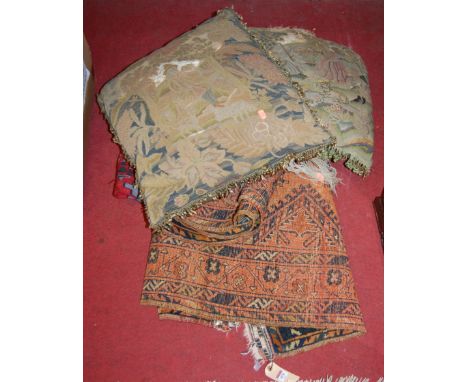A 19th century embroidered panel fashioned into a cushion, one other later example, together with a kelim rug and a rust grou