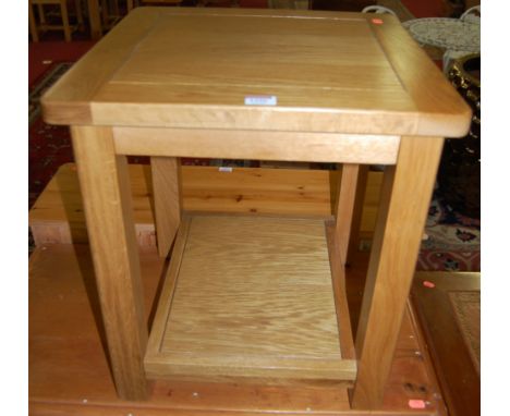 A contemporary light oak two-tier small occasional table, w.45cm