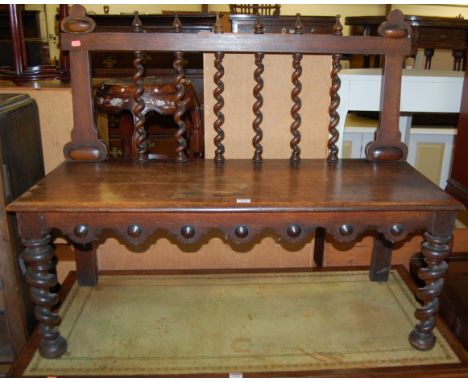 A late Victorian oak panelled seat hall bench, having spiral turned supports, w.107cm