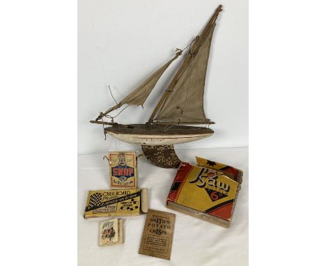 A small collection of assorted vintage toys to include and wooden pond yacht. Lot also includes: Cow &amp; Gate snap game, bo