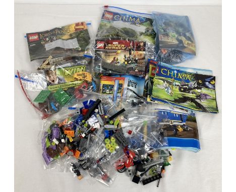 A collection of assorted Lego play pieces and instruction manuals. To include: Chima, Lord of the Rings, Hero Factory and Mar