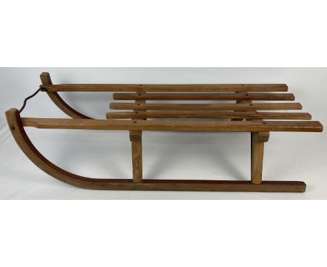 A vintage Davos Germina wooden sled with metal runners. Approx. 93cm long. 