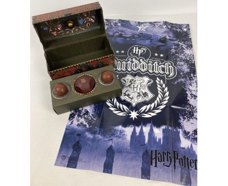 A boxed Harry Potter Collectible Quidditch set with poster. Box in the style of a travelling trunk housing replica quidditch 