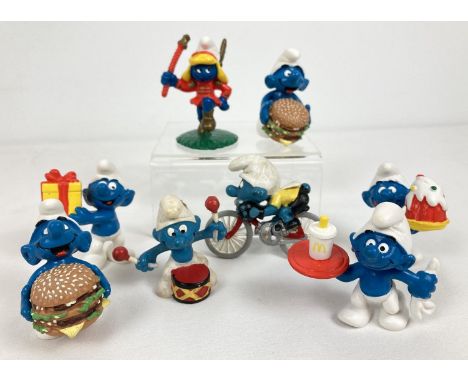 A collection of 8 Macdonald's and vintage Peyo Smurf figures. Comprising: 2 x burger, girl Smurf majorette, waiter, birthday 
