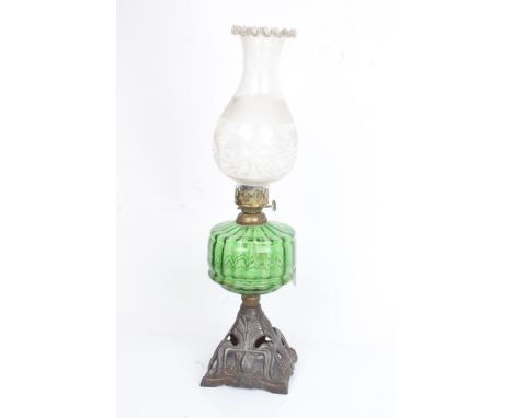 Falks British Make oil lamp, the foliate etched shade above a green glass reservoir and pierced Art Nouveau style steel foot,