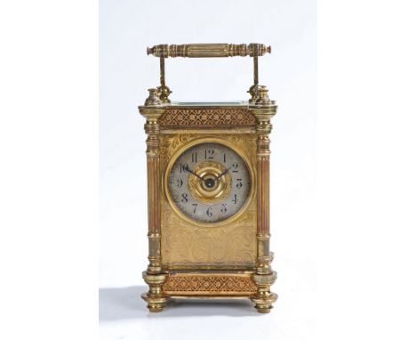 French gilt brass carriage clock, early 20th Century, the reeded swing handle above a bevelled glazed case and fret mounts wi