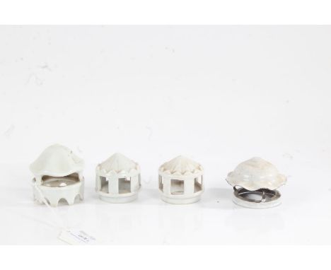 Three porcelain and one white enamel oil lamp chimney caps (4)