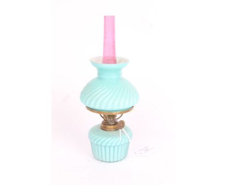 Spar Brenner small oil lamp, the ruby glass chimney above a frosted swirled turquoise shade and reservoir, 23cm high
