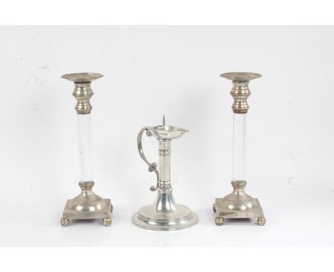 Pair of silver plate mounted candlesticks, the plated drip pans with gadrooned borders above clear perspex stems, domed lower