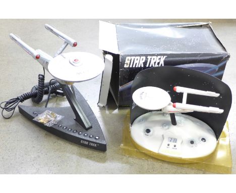 A Star Trek U.S.S. Enterprise novelty telephone, a Star Trek talking alarm clock and a Star Trek metal badge