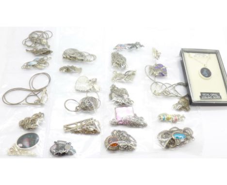 Twenty-five silver pendants and chains including one Capricorn set with opal