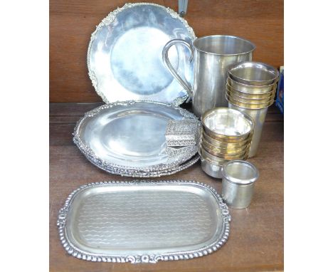 An Indian white metal tray, marked 'silver', six plates with decorated rims, a white metal jug and six beakers, six white met