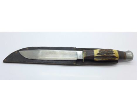 A Bowie type knife with leather scabbard, the scabbard marked made in England