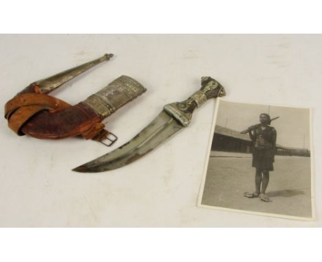 A late 19th/early 20th century kindjal with shaped scabbard, white metal mounts, and with photograph, stamped to the reverse 