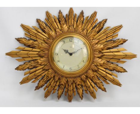 A Smith's gilt moulded sunburst wall clock "Sectric", with Arabic numerals to the chapter ring, diameter 66cm.