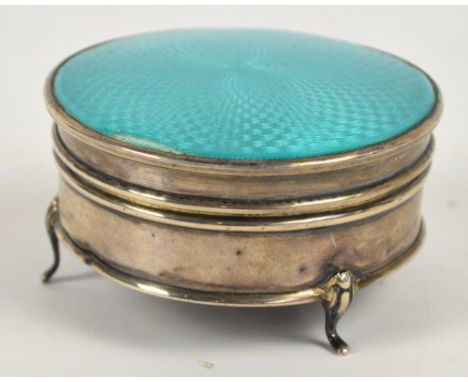 A George V hallmarked silver and turquoise guilloche enamel decorated circular jewellery box raised on three outswept support