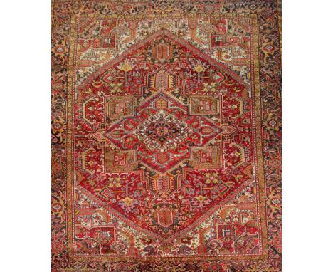 A Persian designed red ground carpet with allover floral decoration. CONDITION REPORT: 272cm x 352cm.