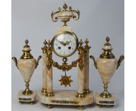 A late 19th century French ormolu mounted and beige marble clock garniture, the circular enamel dial set with Arabic numerals