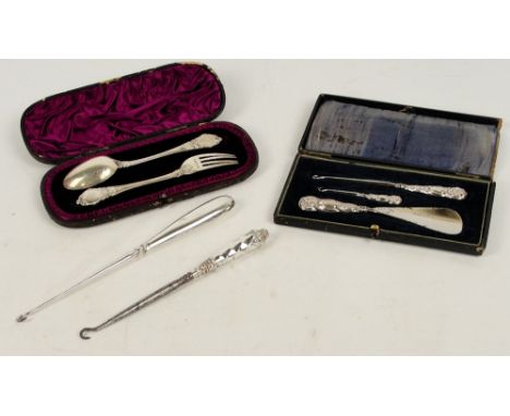 A cased Victorian hallmarked silver spoon and fork, London 1888, a cased silver sheath handled three piece travelling case co