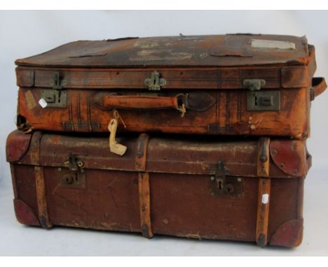 A vintage leather and wood bound travelling trunk, 85 x 51 x 30cm, and a large vintage leather suitcase bearing old stickers 