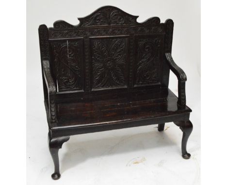 A late Victorian carved oak hall bench.