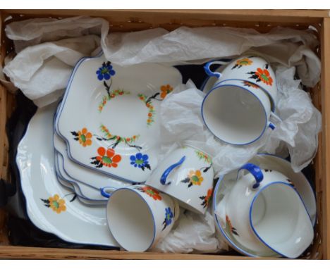 A part tea set of Grafton china with floral hand painted decoration, comprising four cups, six saucers and side plates, a cre