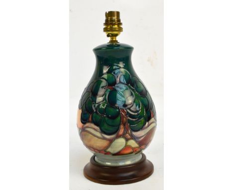 A Moorcroft "Mamoura" pattern tube line decorated lamp base attached to wooden baize covered base, height 27cm including fitt