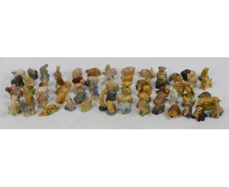 A collection of Wade Whimsies of wild and domesticated animals including lion, pig, penguin, pelican, hedgehog, etc.