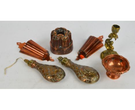 Two Victorian and copper brass mounted powder flasks, one decorated with hanging game, a Victorian jelly mould, a brass candl