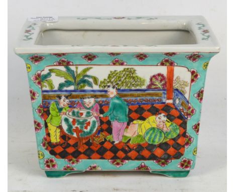 A 20th century Chinese jardiniere of tapering rectangular form, painted in enamels with panel to each side depicting garden s