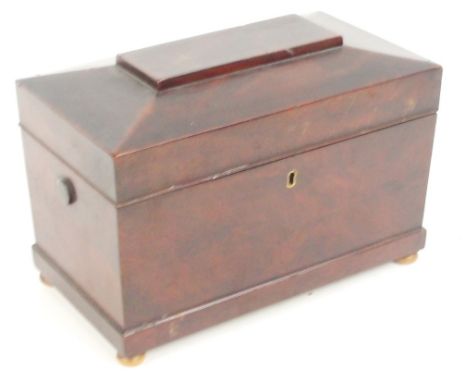 An early Victorian mahogany sarcophagus shaped tea caddy with hinged lid enclosing three compartments raised on vegetable ivo