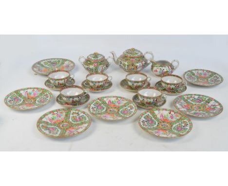 A 20th century Chinese Canton tea set painted in enamel with various figural panels on foliate and floral sprays, comprising 