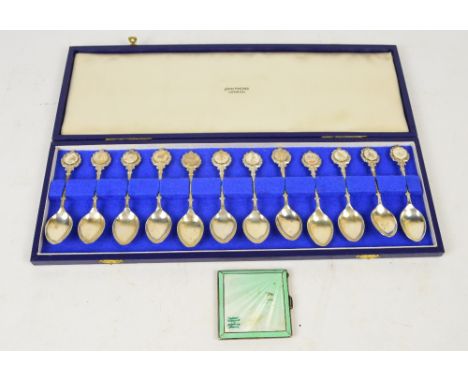 A cased set of Elizabeth II hallmarked silver signs of the zodiac teaspoons, John Pinches, London 1971 and a George V hallmar