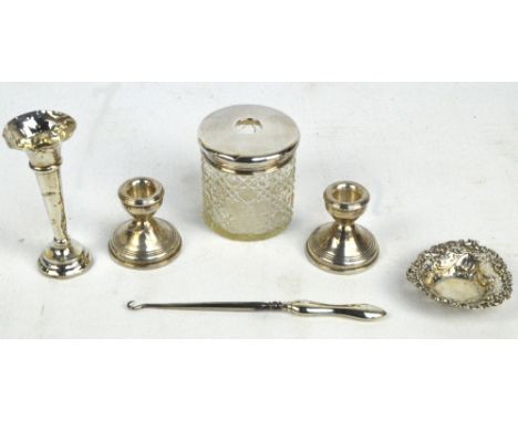 A group of hallmarked silver items comprising a pair of loaded candlesticks, W.I. Broadway & Co, Birmingham 1976, height 6cm,