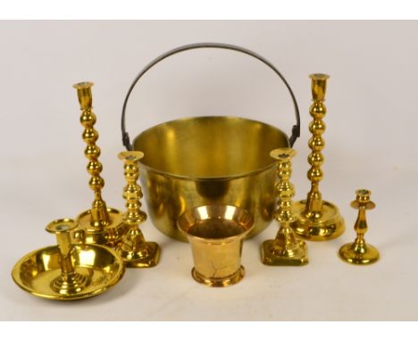 A pair of brass bobbin turned candlesticks, a jam pan, further pair of brass candlesticks, a mortar, single candlestick and a